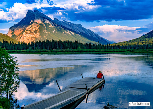 2024-07-18 Woman in red sits on dock in Banff 27517b RFS22564-2xfinal
